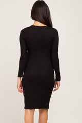 woman wearing a fitted black long sleeve midi dress, view from the back