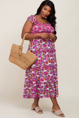 woman wearing a floral print plus-size maxi dress with ruffled sleeves and carrying a woven tote bag