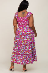 plus size woman wearing a floral maxi dress with a smocked bodice and tiered skirt, showing the back view