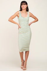 woman wearing a striped midi tank dress in green and cream with a fitted silhouette and side pockets