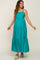 smiling pregnant woman wearing a teal tiered maternity maxi dress with spaghetti straps and white wedge sandals