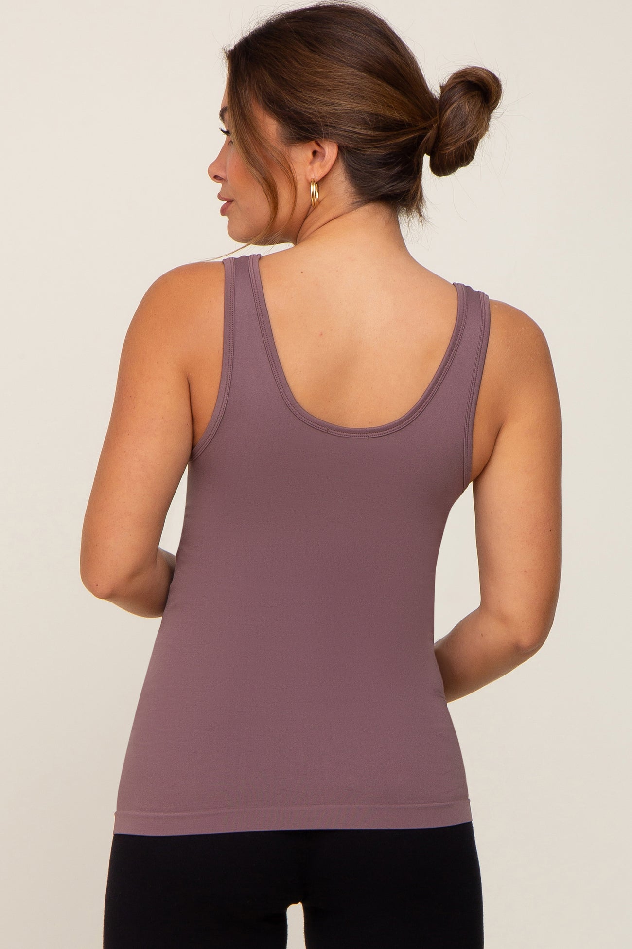 woman wearing a mauve maternity tank top, showing the back view with a fitted style and wide straps