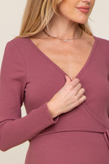 woman wearing a dusty mauve long sleeve maternity wrap dress with a v-neckline and fitted silhouette