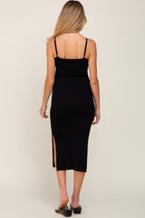 woman wearing a black ribbed maternity dress with a side slit and spaghetti straps, showing her back