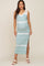 woman wearing a light green and white striped maternity maxi dress with side slits and tie straps, showcasing her baby bump