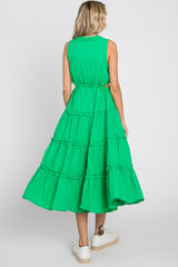 woman wearing a bright green sleeveless tiered midi dress with a cinched waist and a flared skirt