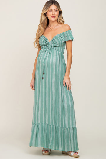 woman wearing a green striped off-the-shoulder maternity maxi dress with a baby bump and tiered bottom