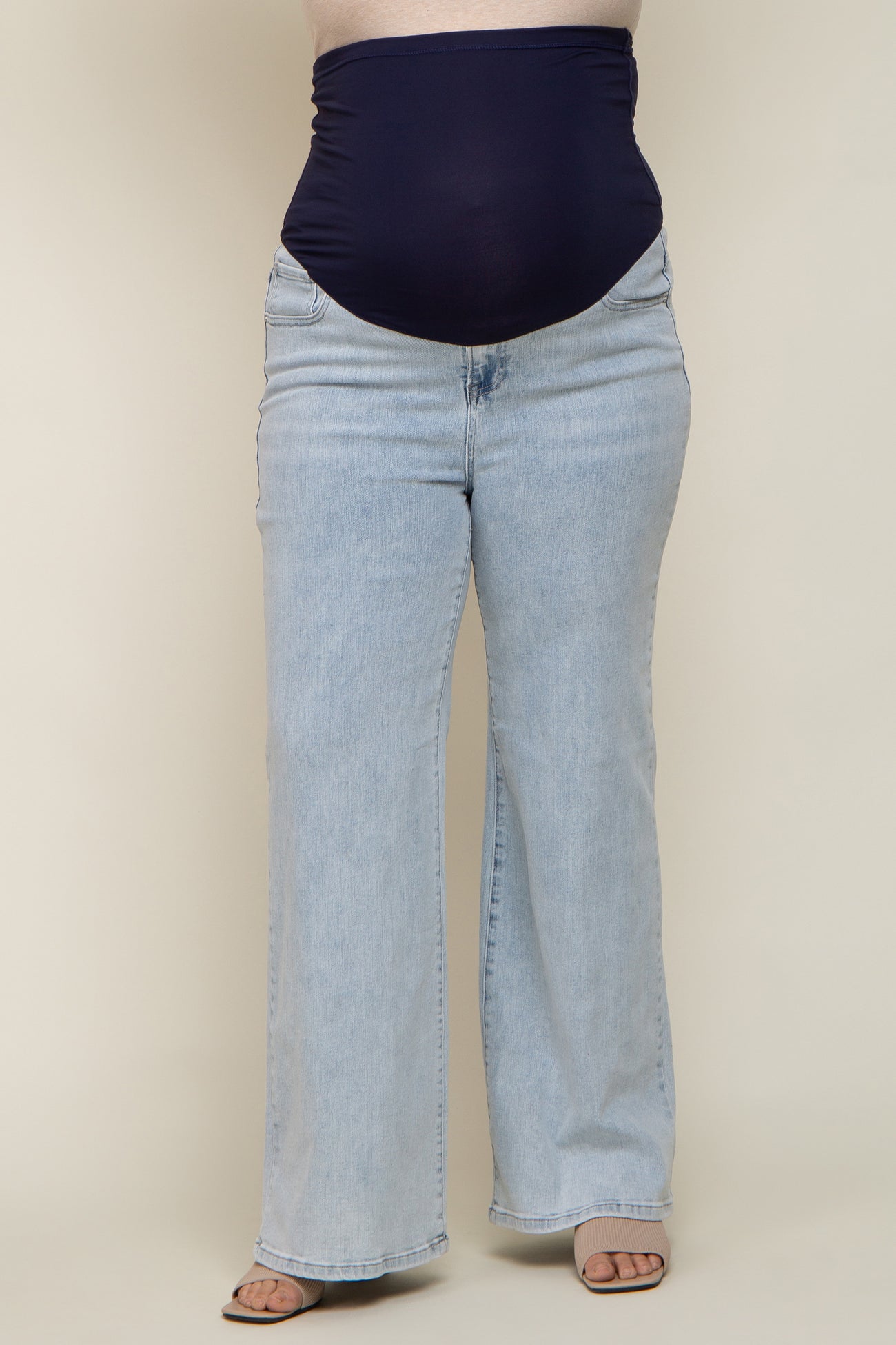 maternity plus wide leg jeans with a dark blue over-the-bump panel, worn by a model showing her baby bump
