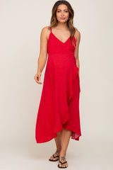 woman wearing a red floral print maternity dress with a v-neck and asymmetrical hemline