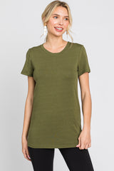 woman wearing an olive green short sleeve crew neck t-shirt and black pants