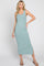 woman wearing a light teal ribbed maxi dress with a side slit and spaghetti straps