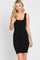 woman wearing a black ribbed bodycon dress with a square neckline and scalloped hem