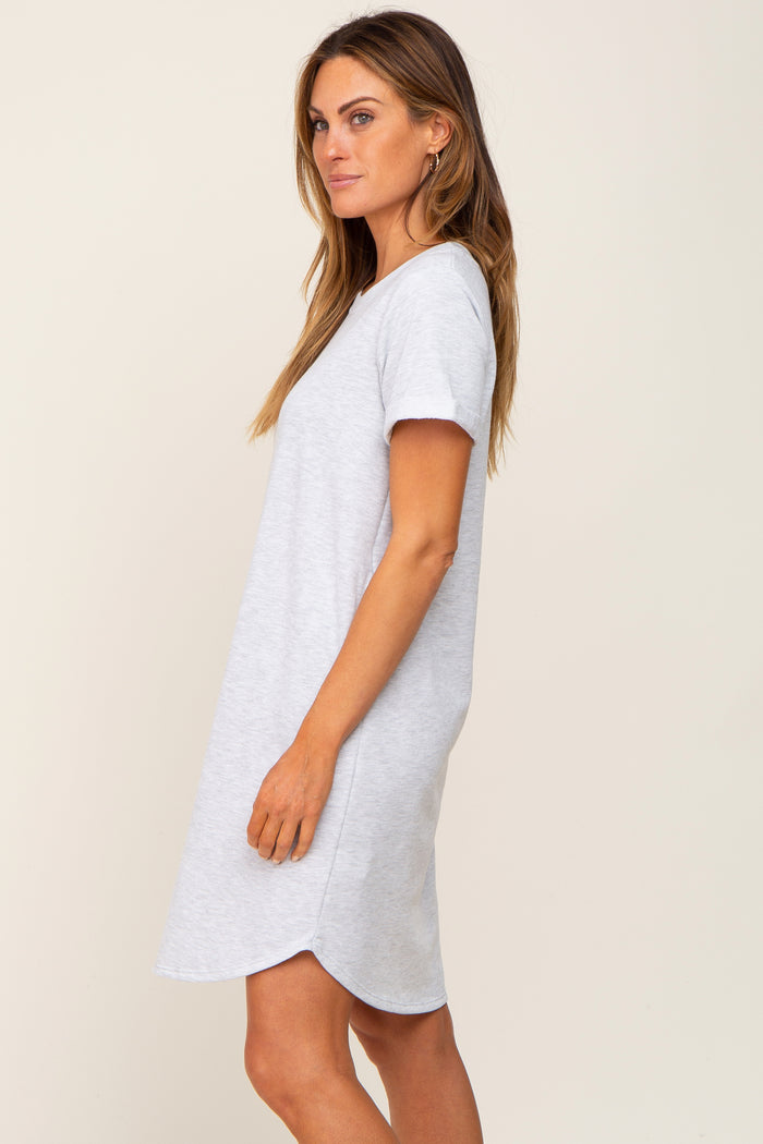 woman wearing a light gray short sleeve t-shirt dress with a curved hem