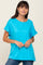 woman wearing a bright turquoise short sleeve t-shirt paired with blue jeans