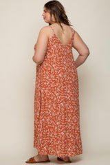 woman wearing a rust colored floral print maternity maxi dress with a v-back and adjustable straps