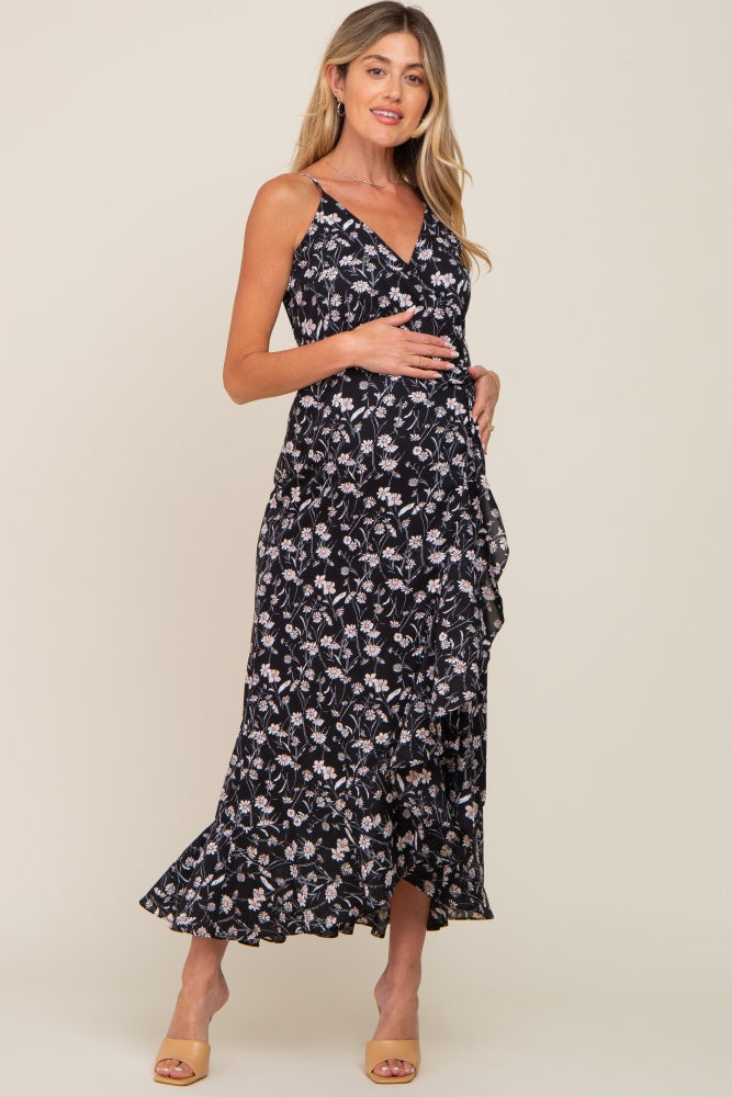 pregnant woman wearing a black floral maternity wrap maxi dress with ruffle trim and tan heels