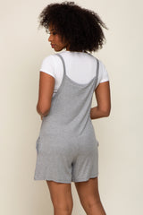 woman wearing a gray short romper with a back view, styled with a white fitted t-shirt underneath