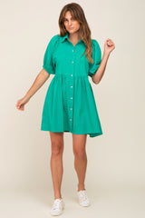 woman wearing a green short puff sleeve button down babydoll dress with white sneakers