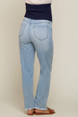 woman wearing light wash distressed maternity jeans with a stretchy navy blue waistband