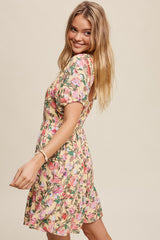 woman wearing a floral short sleeve dress with a fitted bodice and flowy skirt