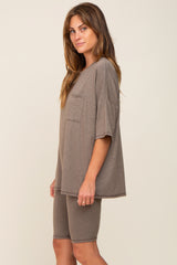 woman wearing a taupe oversized t-shirt with pocket and matching bike shorts