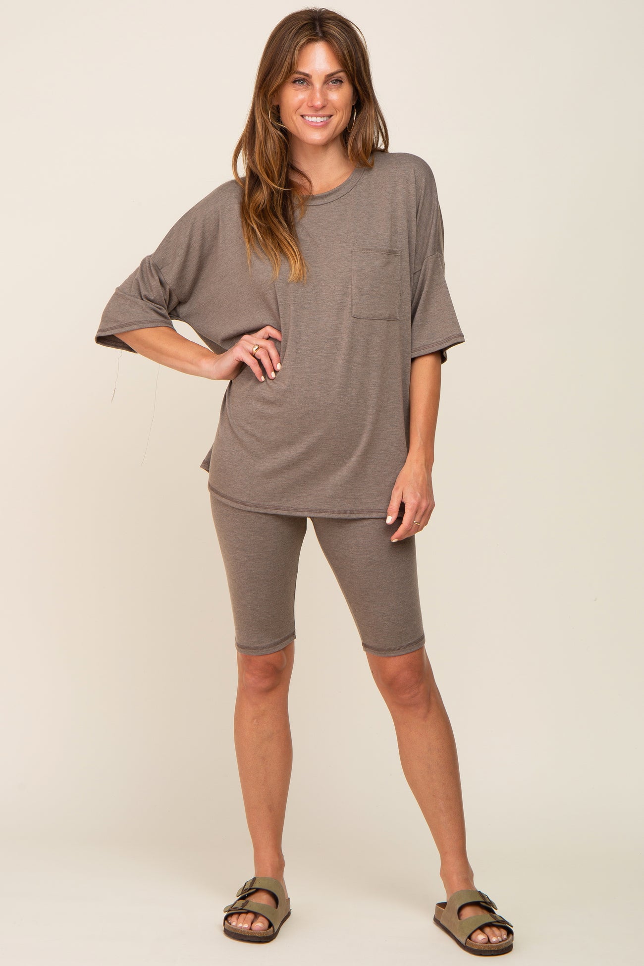 woman wearing brown oversized pocket tee and matching biker shorts lounge set with sandals