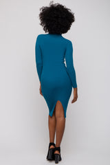 woman wearing a teal ribbed bodycon dress with long sleeves and a side slit, shown from the back