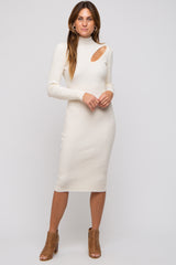 woman wearing a cream ribbed midi dress with a turtleneck and cut-out detail on one shoulder