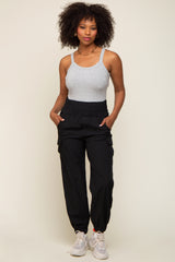 woman wearing a gray sleeveless tank top and black cargo pants with an elastic waistband and side pockets