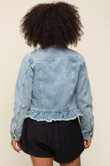 woman wearing a light blue denim jacket with a ruffled hem and long sleeves, viewed from the back
