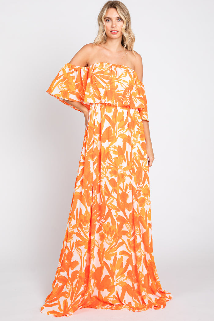 woman wearing an orange floral off-the-shoulder maxi dress with ruffled layers