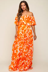 woman wearing an off-the-shoulder orange floral maternity maxi dress with ruffled layers