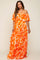 woman wearing an off-the-shoulder orange floral maternity maxi dress with ruffled layers