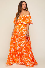 woman wearing an off-shoulder orange floral maxi dress, featuring ruffled sleeves, suitable for maternity wear