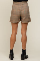 woman wearing maternity plaid shorts, view from the back, featuring a relaxed fit and a comfortable waistband