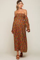 woman wearing a floral off-the-shoulder maternity dress with long sleeves and a visible baby bump