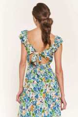 woman wearing a floral backless maxi dress with ruffle sleeves and a tied back detail