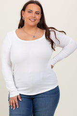 woman wearing a white long sleeve scoop neck top and blue jeans