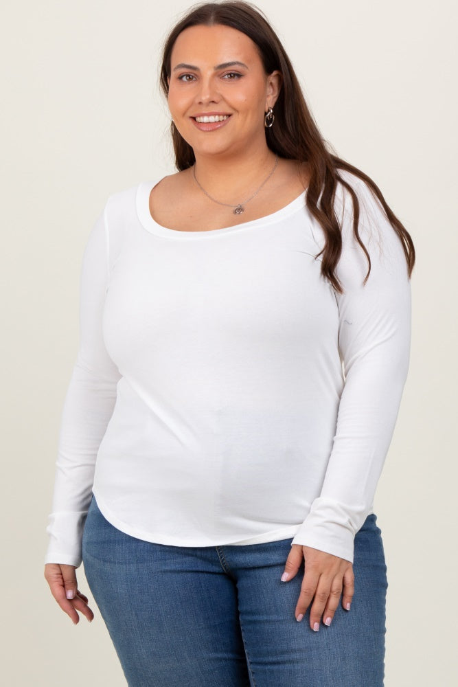woman wearing a white long sleeve scoop neck top paired with blue jeans