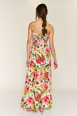 woman wearing a floral maxi dress with pink roses and a fitted bodice, view from the back