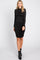 woman wearing a fitted black long sleeve dress with ruching on the sides and black ankle boots