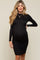 woman wearing a black long sleeve maternity dress with ruched sides and a visible baby bump