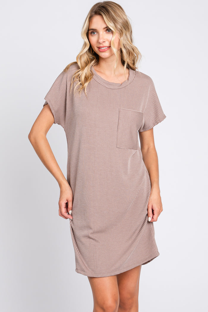 woman wearing a brown and white striped short sleeve dress with a pocket detail