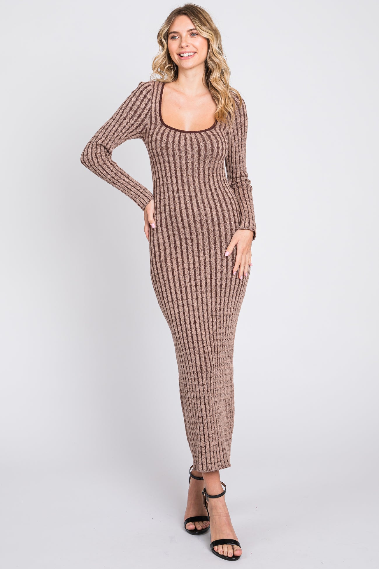 woman wearing a brown ribbed knit long sleeve maxi dress with a scoop neckline and fitted silhouette