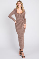 woman wearing a brown ribbed knit long sleeve maxi dress with a scoop neckline and fitted silhouette