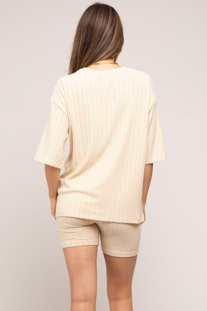 woman wearing a cream striped maternity loungewear set, featuring a loose t-shirt and matching shorts, viewed from the back