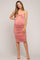 woman wearing a pink ruched maternity dress with spaghetti straps and a visible baby bump