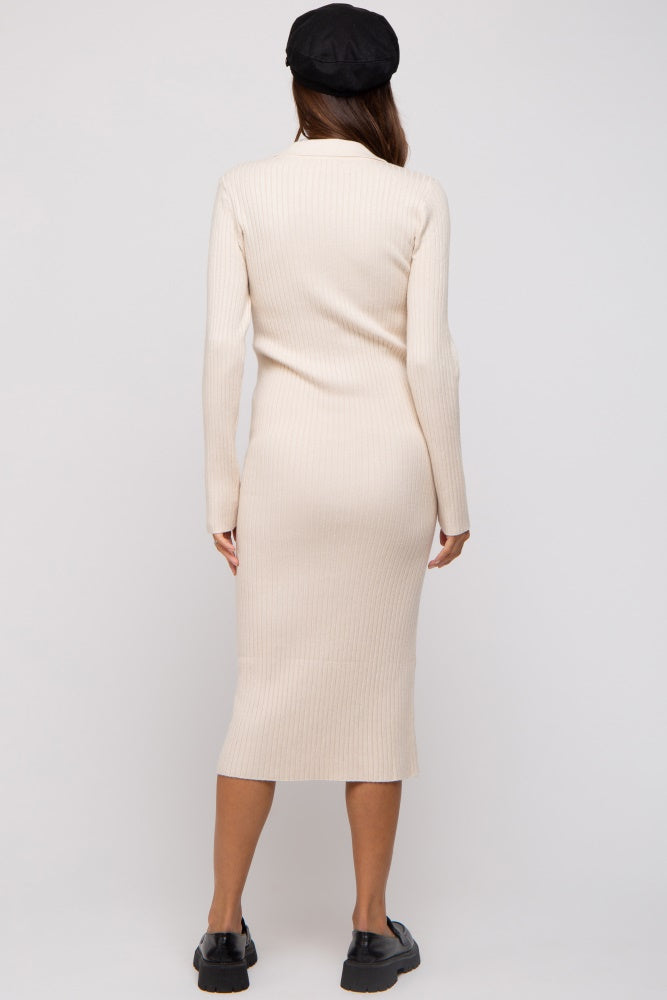 woman wearing a beige long sleeve ribbed maternity dress, showing a fitted silhouette from the back