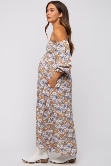 woman wearing a floral off-the-shoulder maternity maxi dress with a visible baby bump