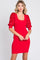woman wearing a red ribbed dress with sequin-embellished puff sleeves